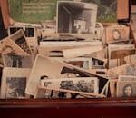 A collection of old black-and-white photographs stored in a vintage wooden box, evoking nostalgia.
